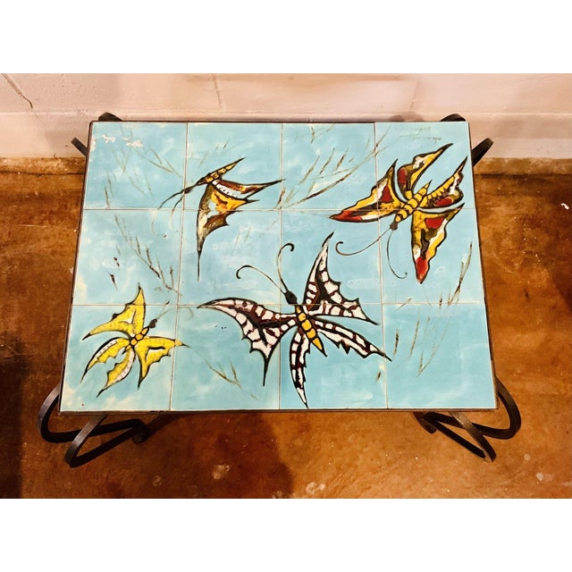 Signed, hand painted tiles from Vallauris, France top off this hand forged iron coffee table. Playful butterflies. Mid...