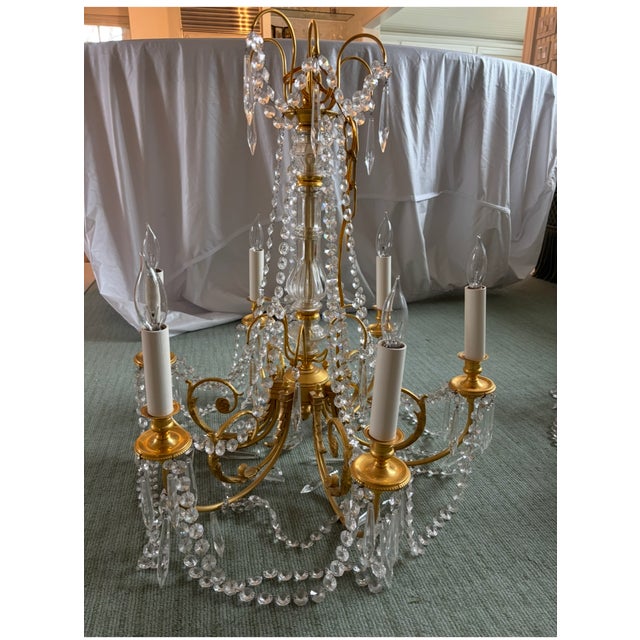 Pair of 6 light French style brass and crystal chandeliers, with crystal swags and drops and center hanging crystal ball....