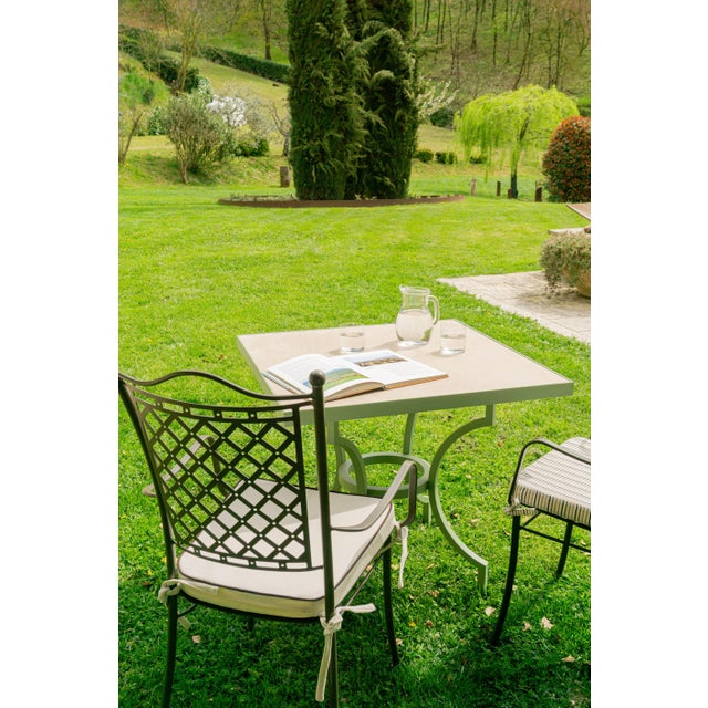 Alnilam is an outdoor table with a travertine top and metal frame, made in Italy, distinguished by its compact proportions...