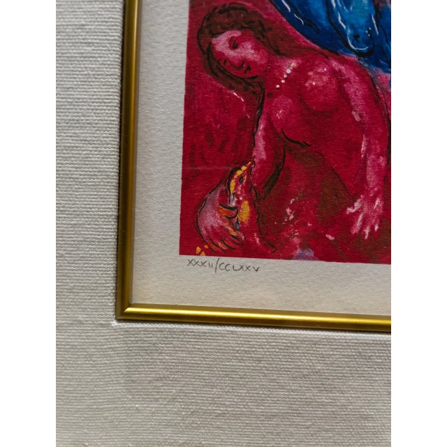 A framed Marc Chagall (1887-1985) "Les Soucis" giclee print with facsimile signature depicting bright colorful flowers,...
