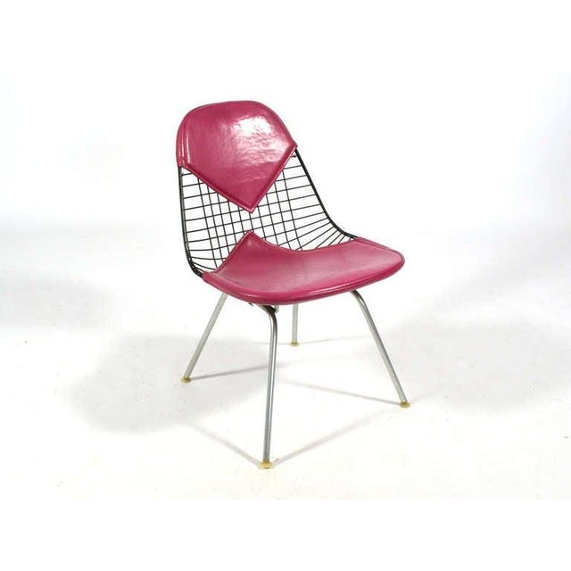 This terrific example of the Eames LKH-2 easy chair has a black wire seat, a bikini pad in magenta naugahyde designed by...