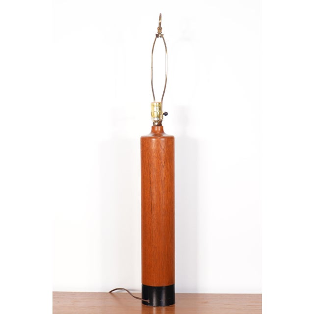 Handcrafted by ESA, this 1960s Danish lamp features a substantial, solid teak base paired with black leather wrap...