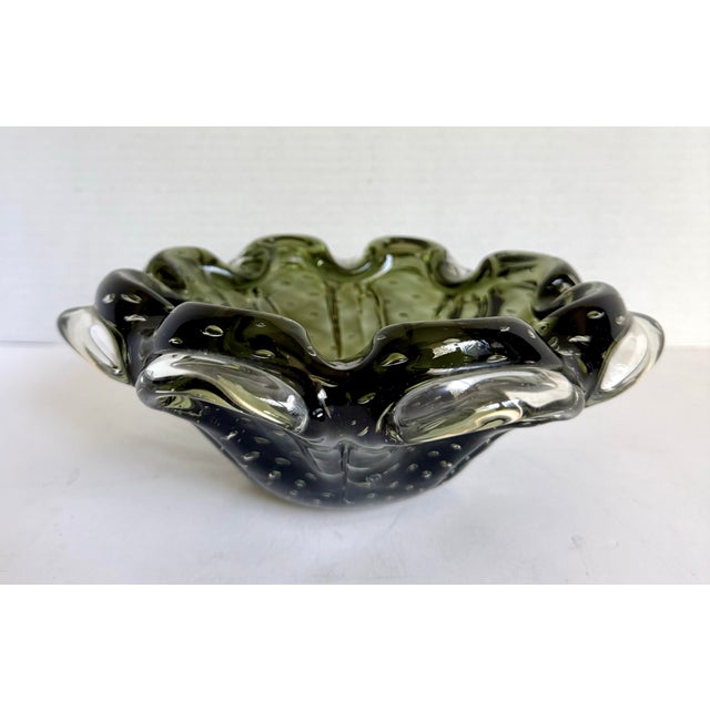 This vintage art glass bowl features a sculptural, organic form with a softly lobed rim and a rich olive green tone cased...