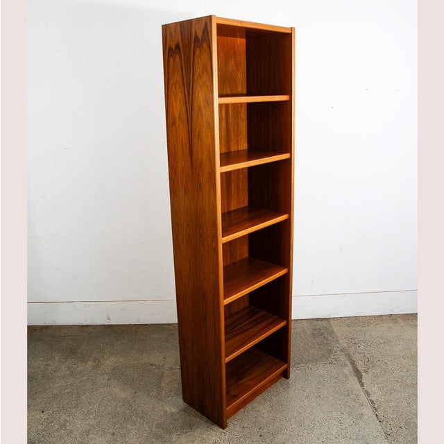 Beautiful and classic teak compact bookshelf. unique size and shape that fits in smaller spaces. Marked "Made in Denmark"....