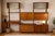 An elegant 1960s wall-mounted bookcase in teak veneer, enhanced by discreet brass handles. A warm and inviting design that...