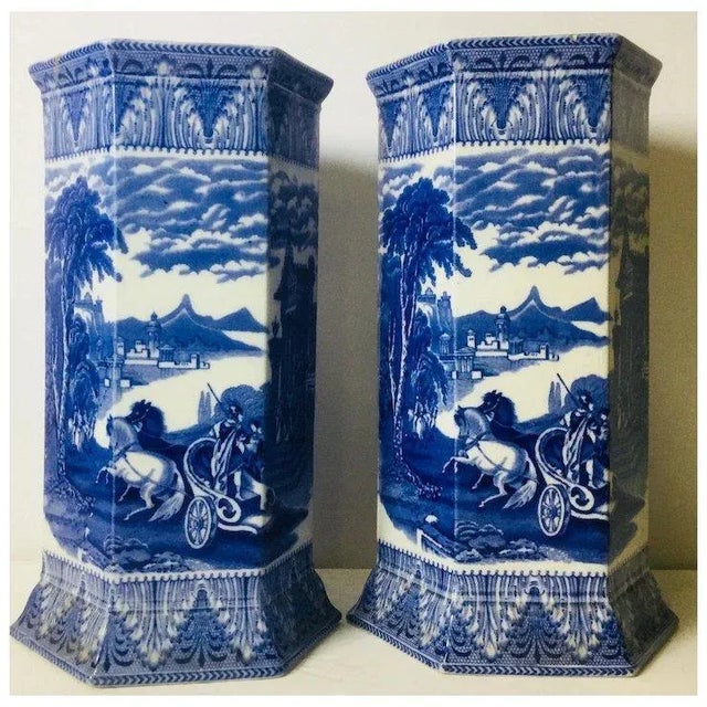 Antique Cauldon Vases. Measure 10 1/4 tall. Hairline crack in one and it’s lip, and slight discoloration on bottoms.