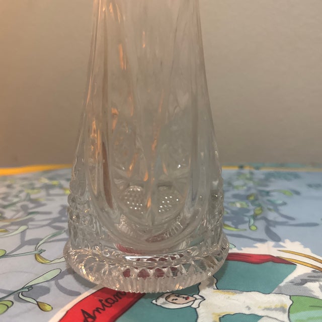 An elegant and striking Mid-Century Modern clear swung glass trumpet vase. This vintage piece features a slender,...