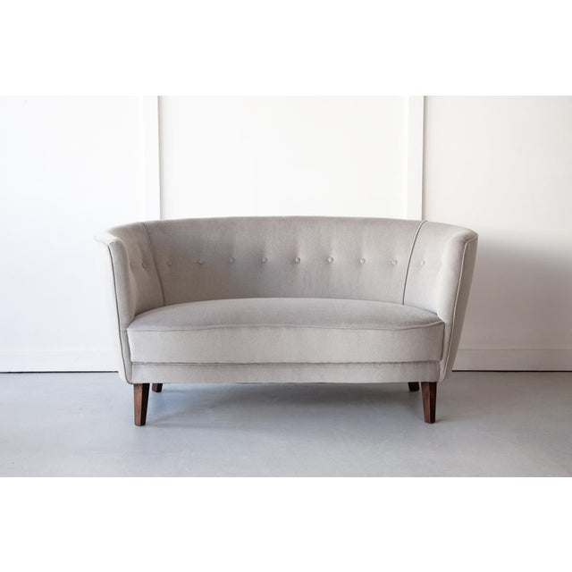 A very sweet and compactly sized 1930's Danish 'Banana' sofa featuring excellent design and craftsmanship. The shape is...