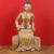 A Burmese hand carved and gilded seated woman statue from the 19th century, in traditional costume. Created in Burma...