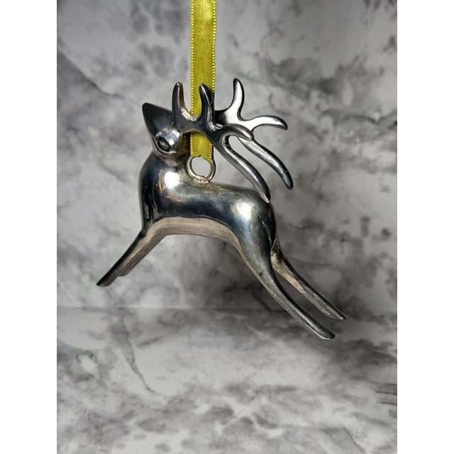 Fabulous pair of chrome polished reindeer ornaments with green ribbon. These would make the perfect addition to your...