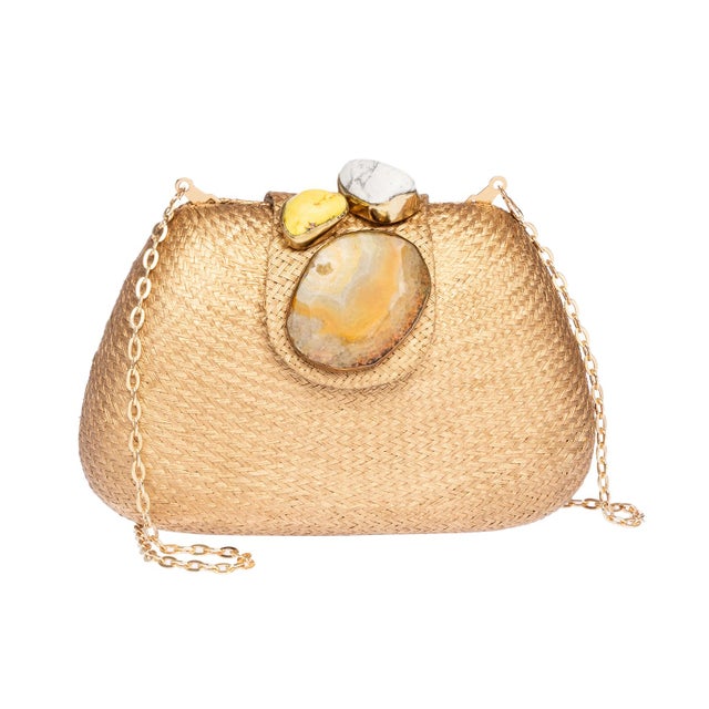 Clutch in gold buntal with multi-stone closure and silk tassel. Fully lined with drop in gold chain strap.