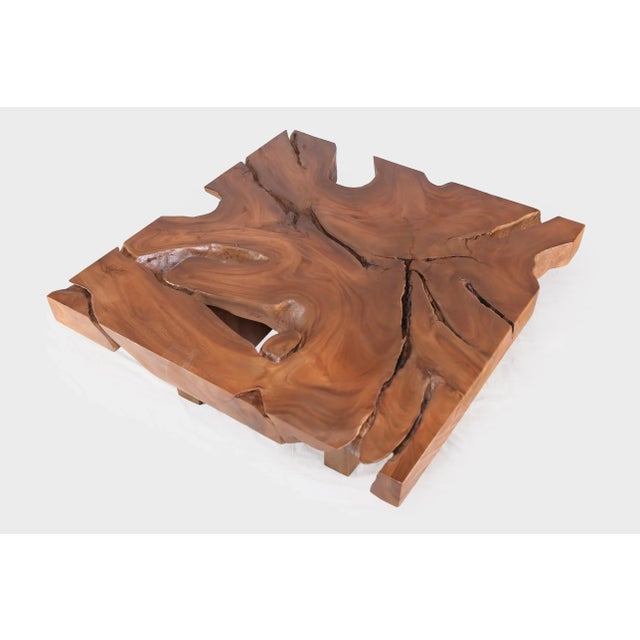 Hand made from one single slab of wood, the top of this organic cocktail table is hand selected, cut, and polished to...