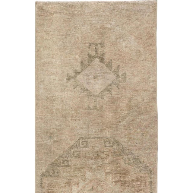 This mid-20th-century Turkish Anatolian long runner presents a restrained procession of large octagonal medallions...