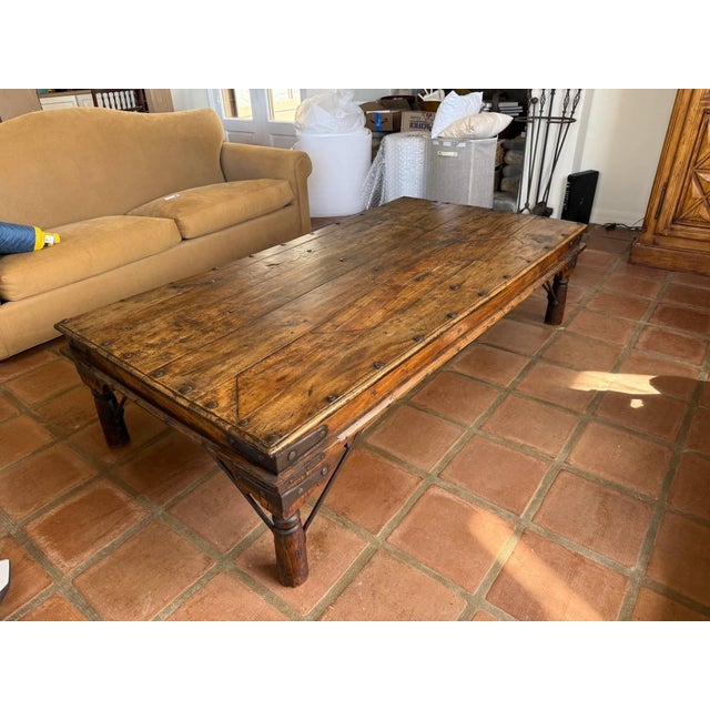 A substantial Spanish Colonial Revival coffee table, showcasing bold craftsmanship and old-world character. Constructed...