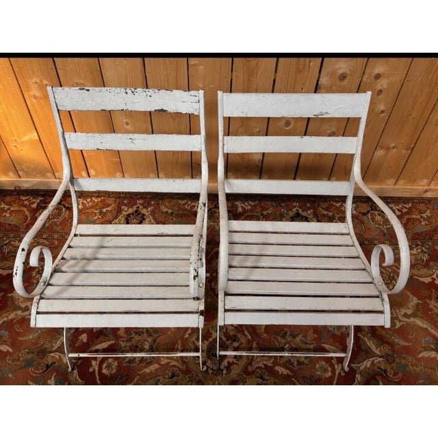 A superb pair of 19th-century French garden armchairs, elegant testaments to the French art of living. Their wrought-iron...