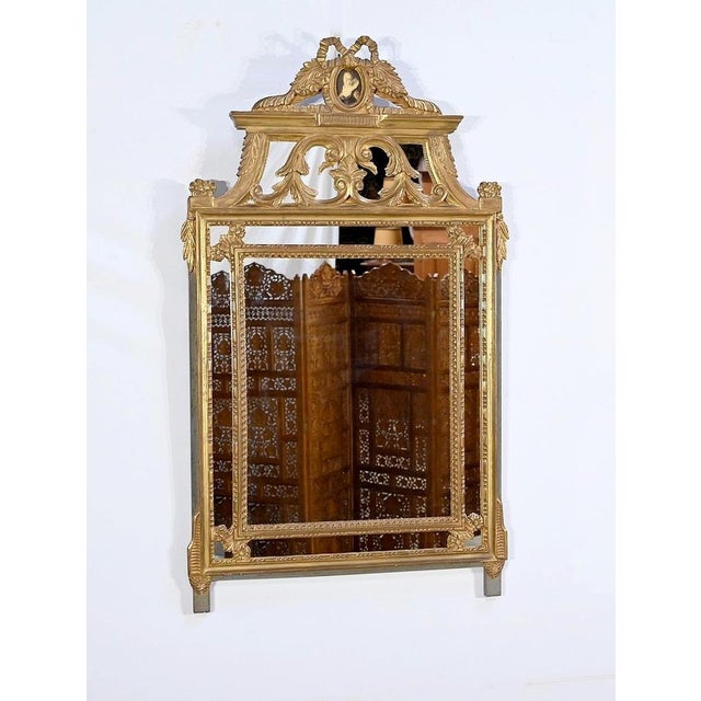 This large Louis XVI mirror is composed of a framing of two golden wooden moldings, scalded. We find garlands of pearls...