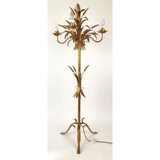 A gilt metal floor lamp from Italy made in the 1960s. This four element candelabra is made up of sheet metal, cast...