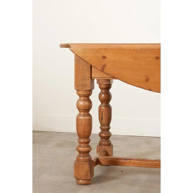 Dimensions: 30 ¾” H x 78 ½” W x 44” D An English drop leaf dining table made of solid pine, easily converting between a...