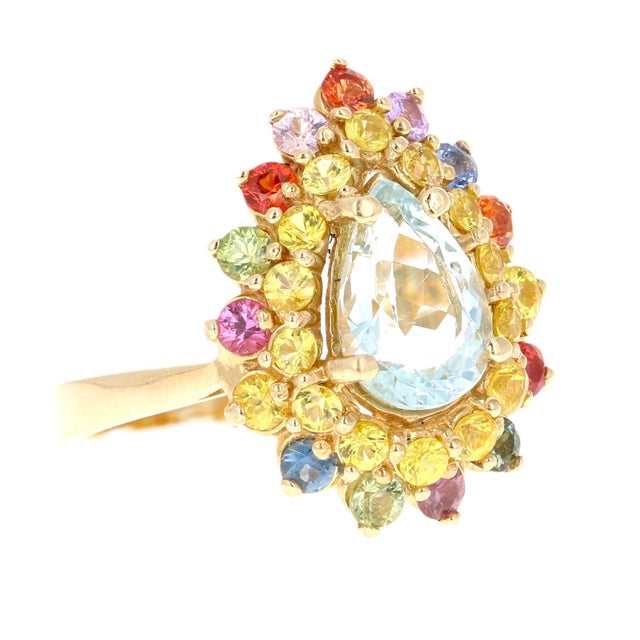 This ring has a gorgeous 1.65 Carat Pear Cut Aquamarine and is surrounded by 30 Round Cut Multicolor Sapphires that weigh...