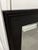 A large rectangular mirror in a dark wood frame with a beveled glass edge. Originally mounted atop a dresser, this mirror...