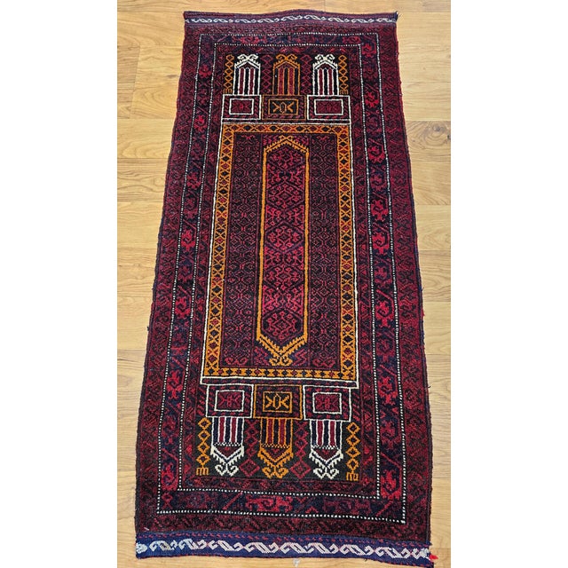 1' 8" x 3' 8" Wonderful small tribal Baluch area rug from the mid 1900s. The beautiful small area rug is hand knotted in a...