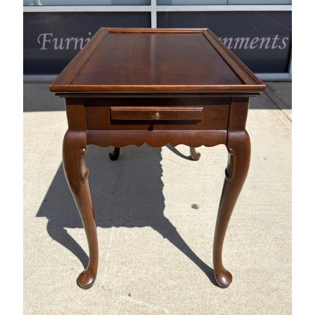 This Ethan Allen tea table is crafted in solid cherry and features a classic Queen Anne design with graceful cabriole...