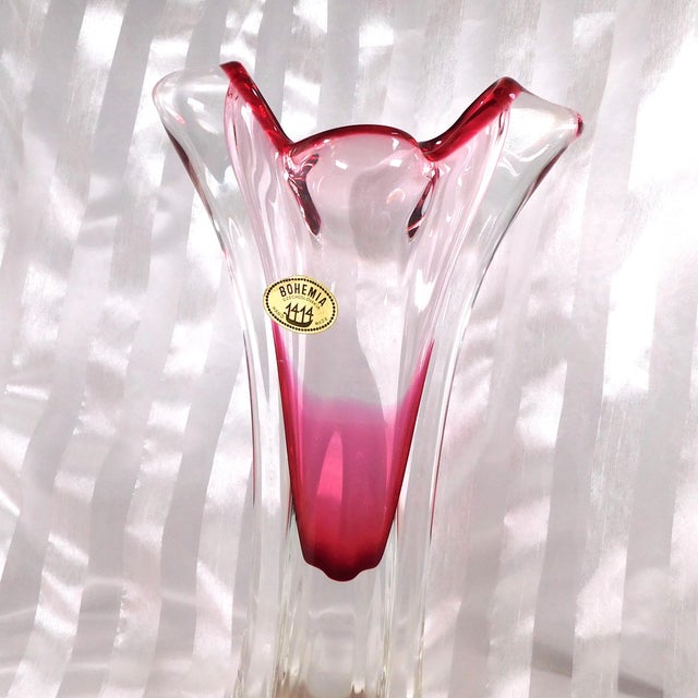 This is a pink cased in clear Bohemia art glass vase. The vase section is a bit short-In my opnion and it is pink at the...