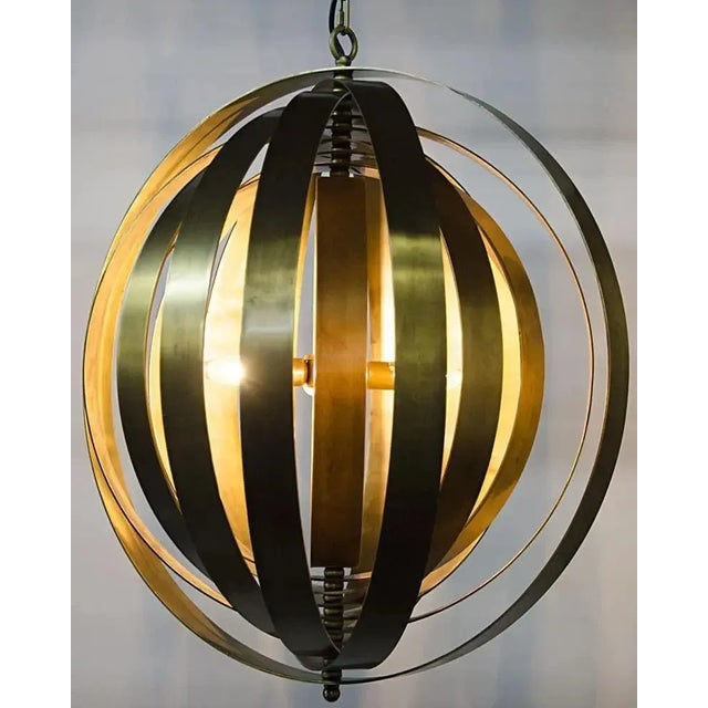 Illuminate your surroundings with the Tournant Pendant, a captivating blend of industrial steel and Antique Brass finish....