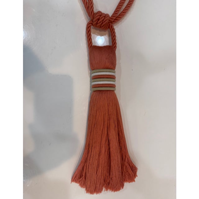 A straight skirt, single tassel tieback secured with a multi-tier cord wrapping. The color is 08 Melon. This color is now...