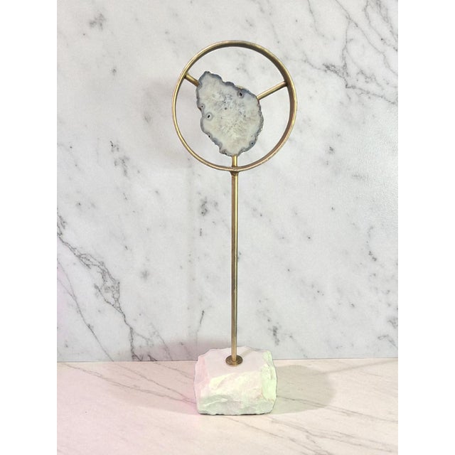 This product consists of a unique decorative sliced agate stone set on a marble stand. The sliced agate stone showcases...