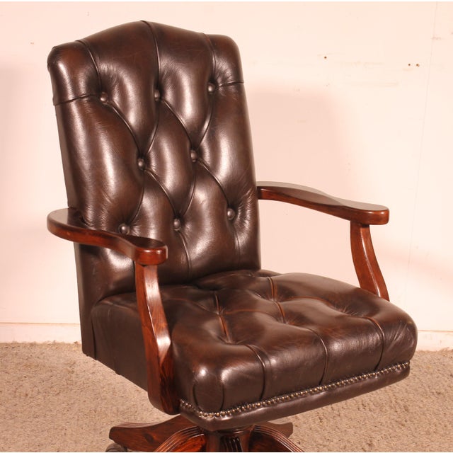 Charming 1950s English executive chair in leather and polished wood. Very handsome chair with a polished wood base and...