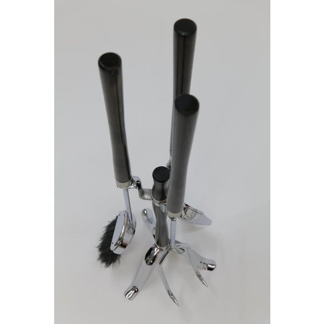 This vintage Hollywood Regency-style fireplace tool set combines chrome and wood accents for a sleek yet luxurious look,...