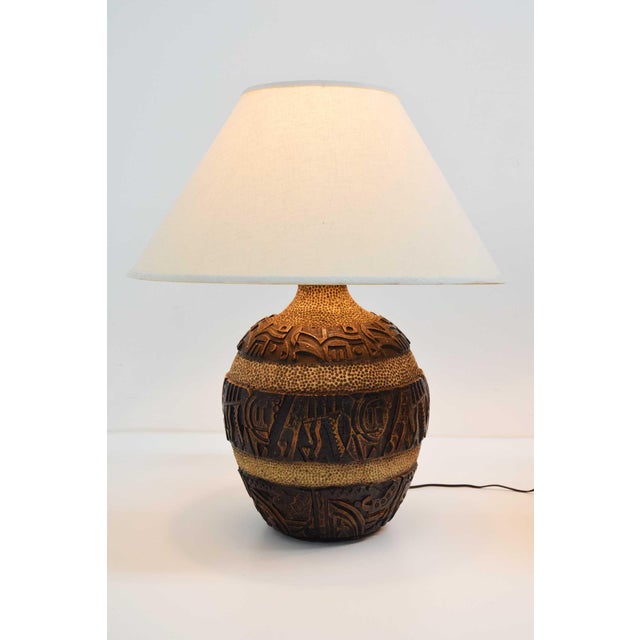 Discover the charm of mid-century design with this beautiful pair of very large bulbous ceramic lamps with heavy relief,...