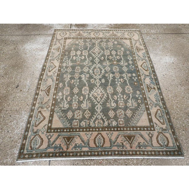 This mid-20th century Persian Malayer rug, measuring 3' 3" x 4' 6", presents a refined interplay of soft tones and...