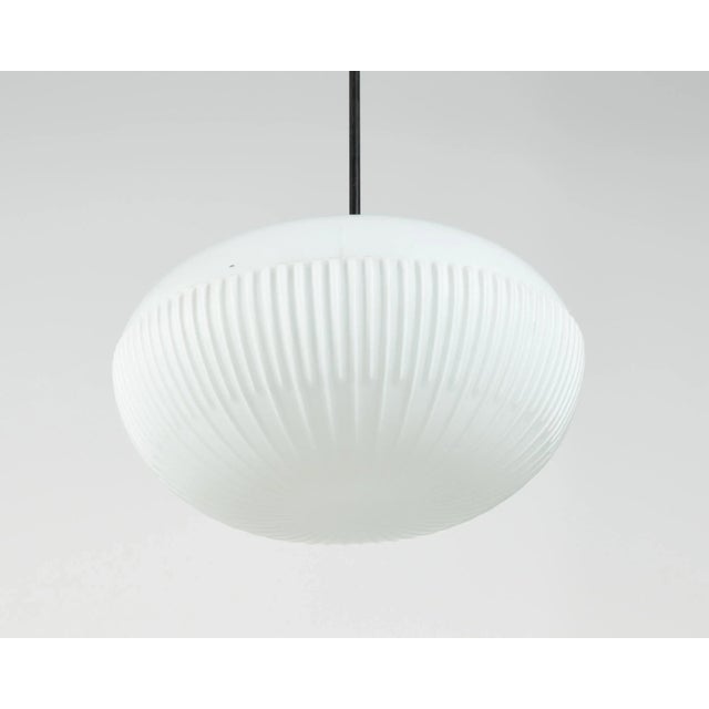 A mid-century ceiling lamp with white opaline glass shade - 25x40 cm. Produced by napako, a national lighting factory in...