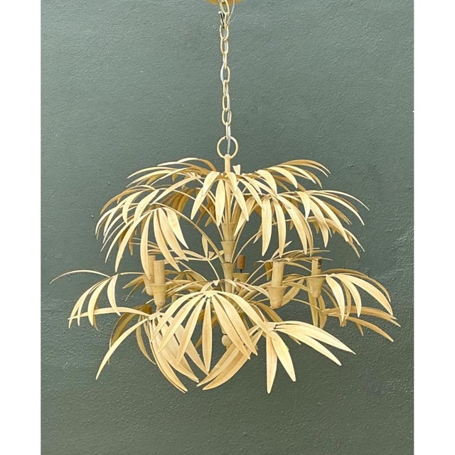 This chandelier reimagines a hanging light fixture as a cascading tropical canopy, with dozens of individually shaped...
