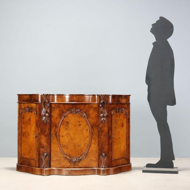 A Louis Philippe walnut sideboard, crafted in Italy in the second quarter of the 19th century, features a rounded...