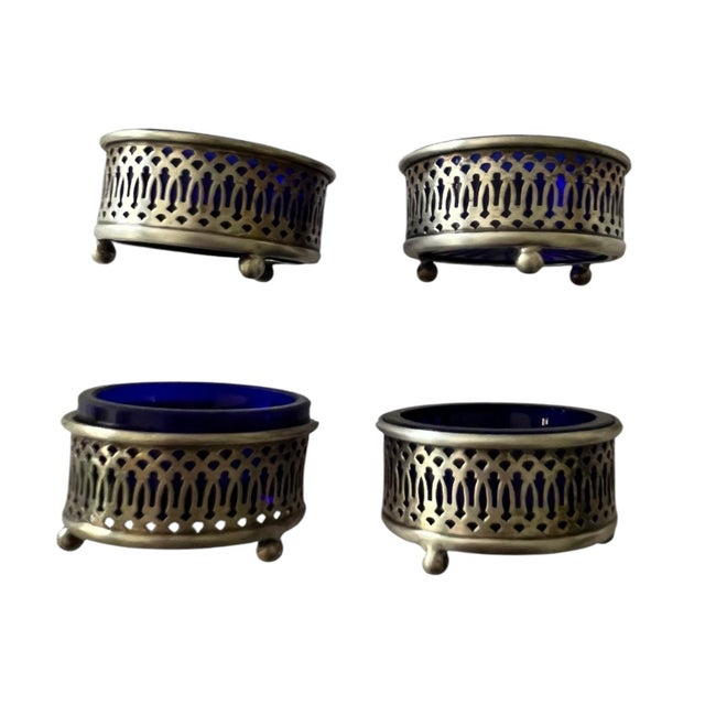 This is an exceptional, matched set of 4 antique sterling silver salt open salt cellars with cobalt-blue glass liners....
