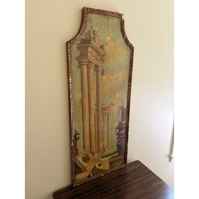 A distinctive Italian capriccio landscape, painted in oil on a shaped panel and presented in a softly worn giltwood frame....