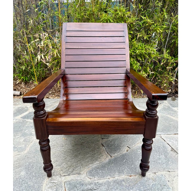 Here is a beautiful chair from the early mid-century made of hardwood with a slatted seat and back design. The chair...