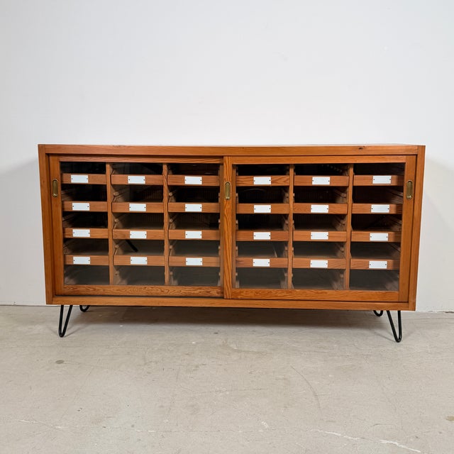 Originally functioning as a commercial sorting cabinet in mid-20th-century Germany, this solid pine piece has been...