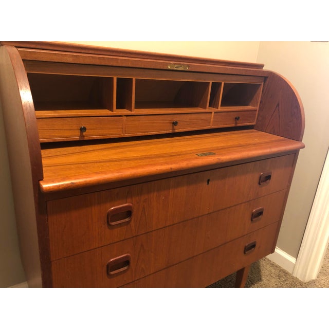 This mid-century teak cylinder roll top desk has three large drawers, great for storage. It is in fine shape and has the...