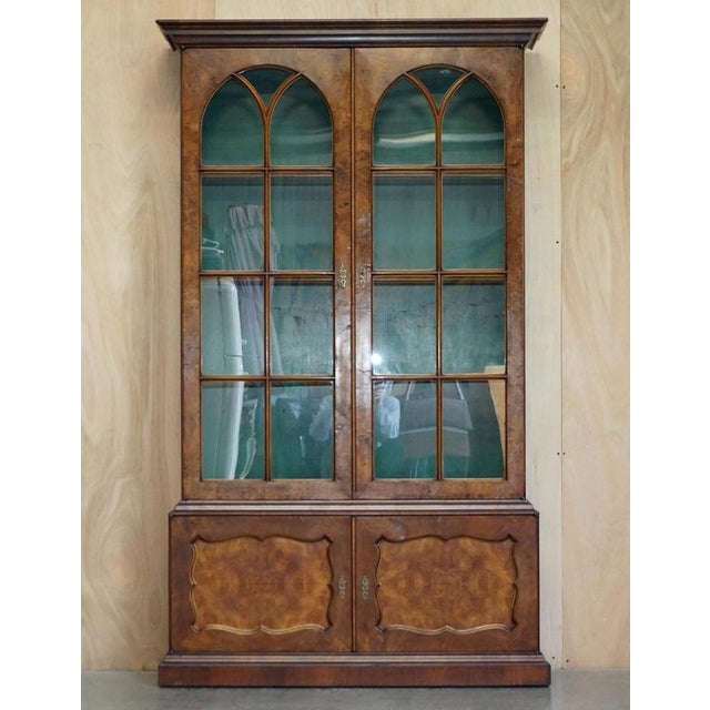 Sublime circa 1880 antique Victorian burr walnut library bookcase with gothic style glazed doors. The bookcase is...