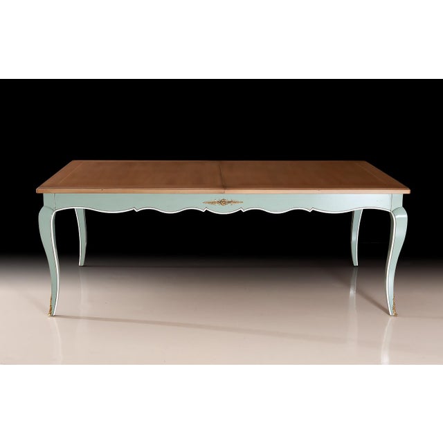 Handcrafted in Italy, this elegant French-style extension dining table pairs a warm natural wood top with a light green...
