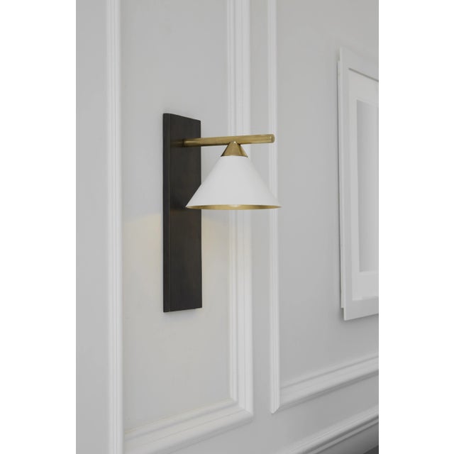 Cleo Sconce in Bronze and Antique-Burnished Brass with Matte White Shade Designer: Kelly Wearstler Height: 14" Extension:...