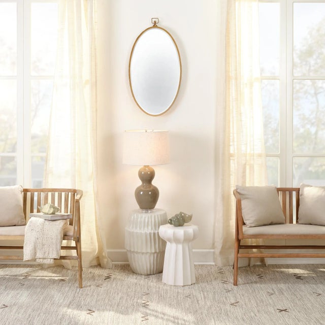 A modern take on an antique-inspired silhouette, this mirror will bring charm to a variety of décor styles. Featuring...