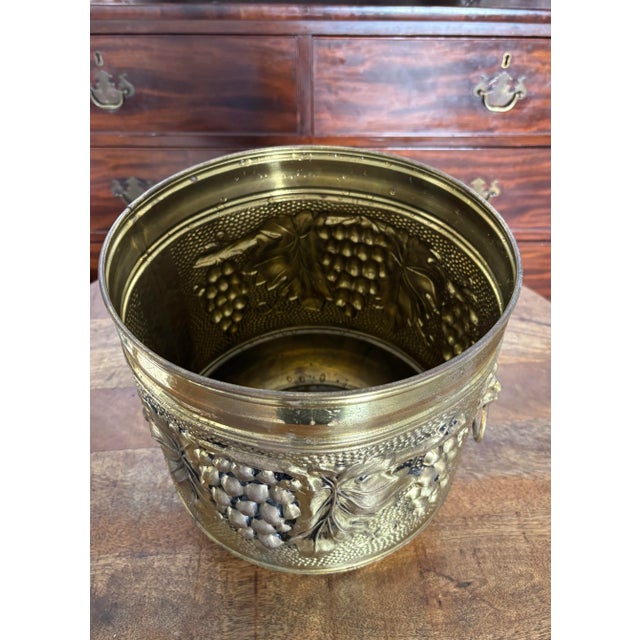 Lovely twentieth century hammered brass planter with grape and leaf design. Made in England with beautiful detail and a...