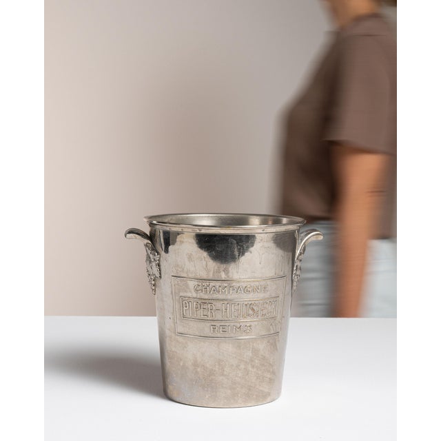 This mid 20th century ice bucket from France is finished in silver. It is engraved with the Argit wordmark, a detail that...