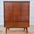 This is a handsome vintage mid century modern walnut veneer tall chest of drawers or highboy dresser. The dresser is...