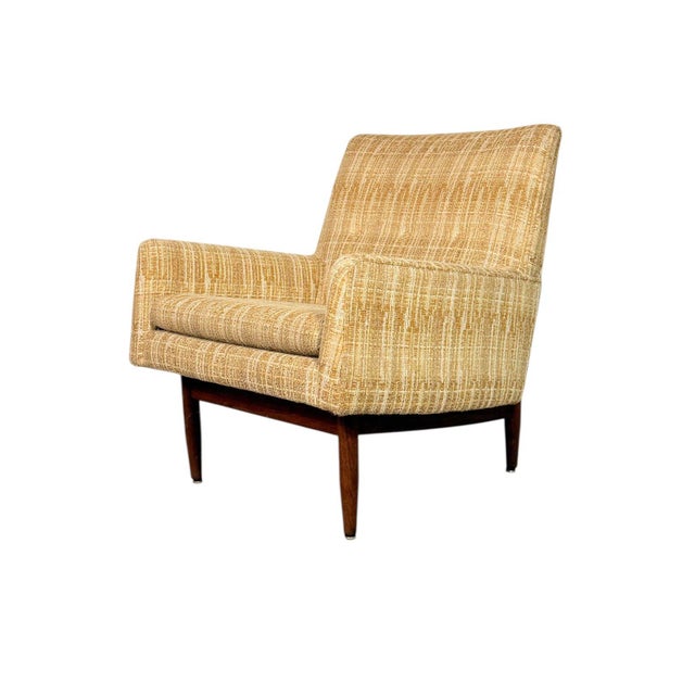Beautiful 1950s Jens Risom lounge chair featuring a solid walnut frame and its original textured upholstery. The chair has...